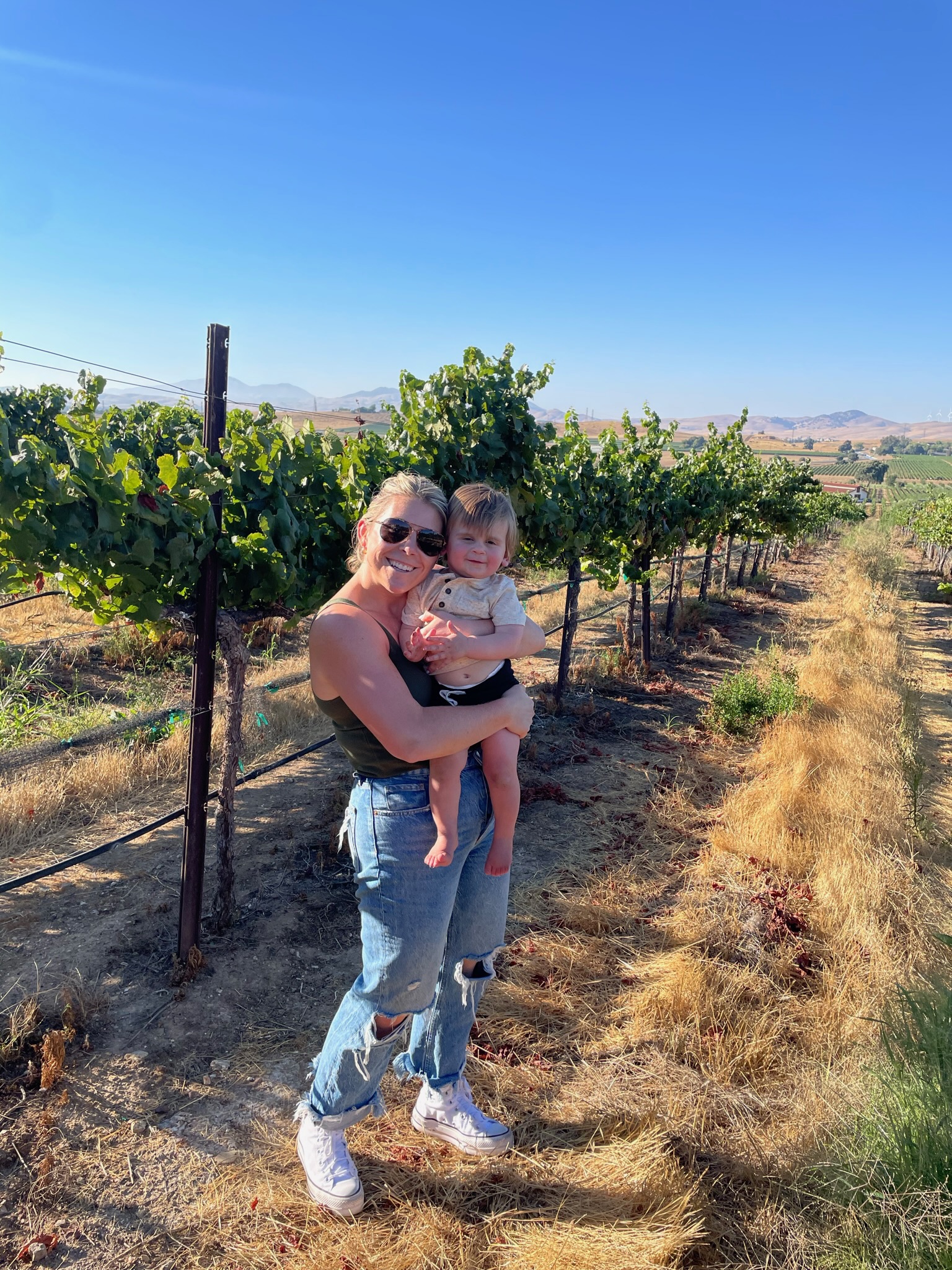 Ally Kurtz with child in the vineyard